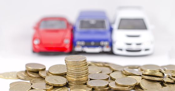 cars in front of gold coins